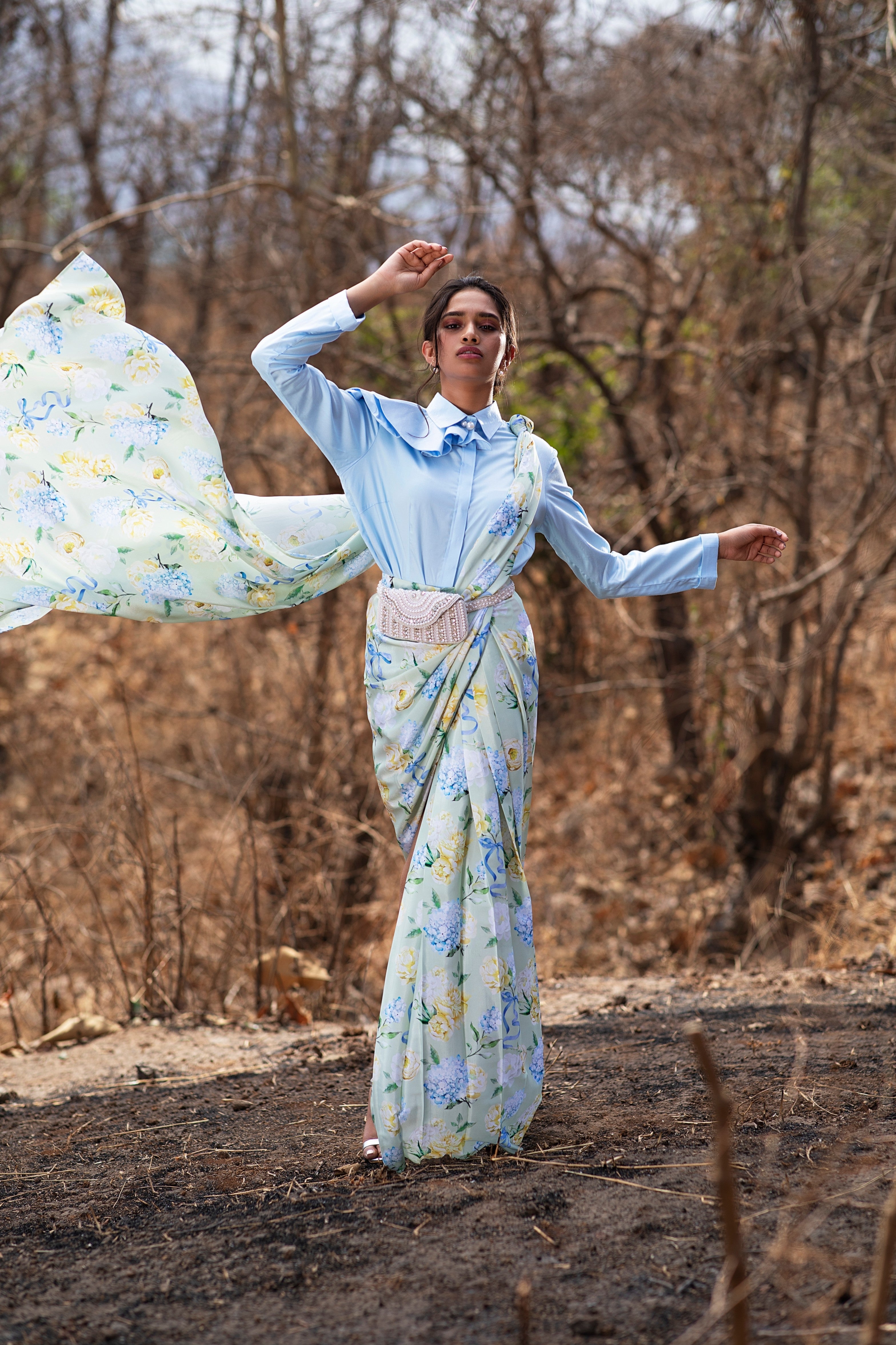 Blue Bows and Blooms printed pre-draped saree and blue structured shirt.