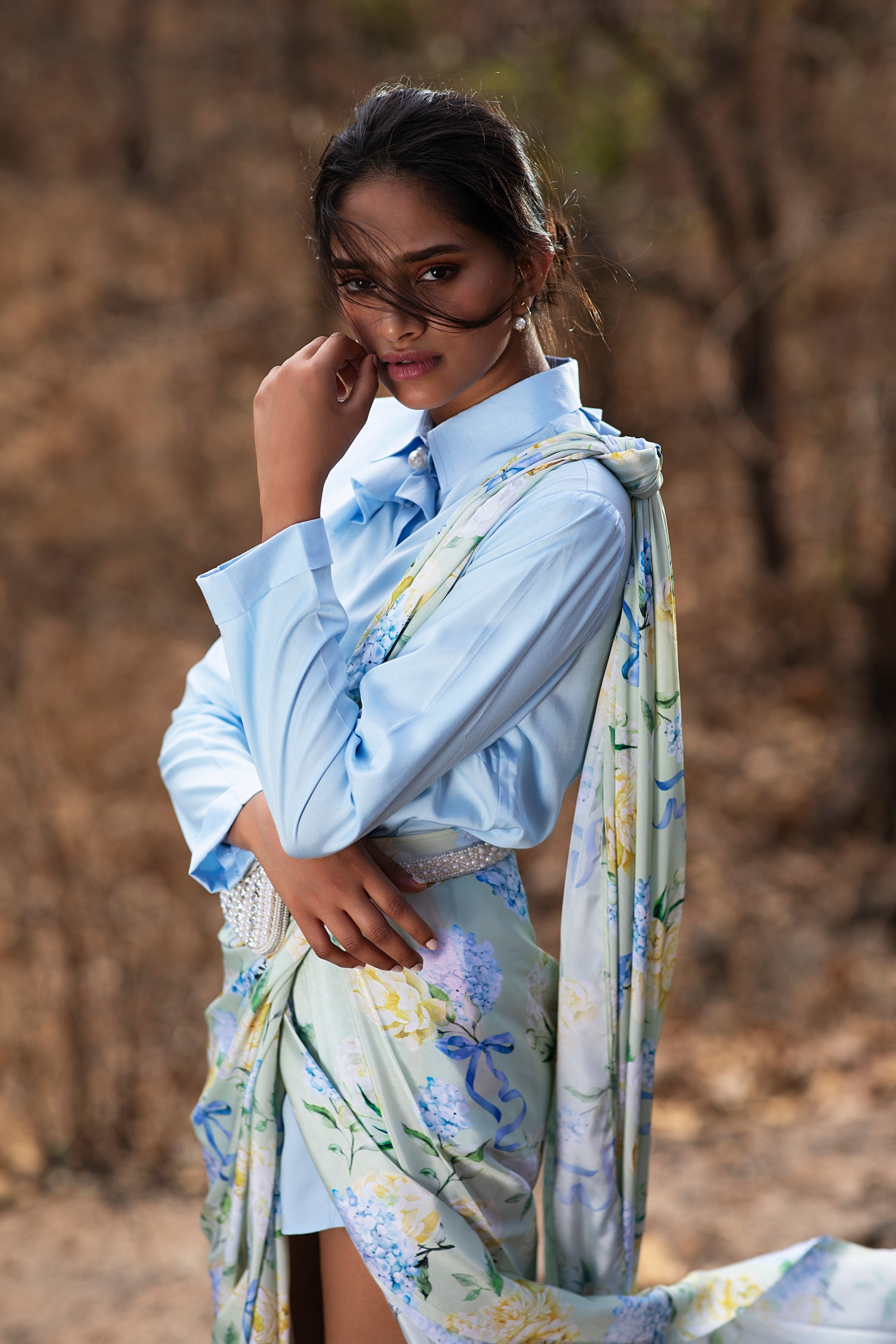 Blue Bows and Blooms printed pre-draped saree and blue structured shirt.